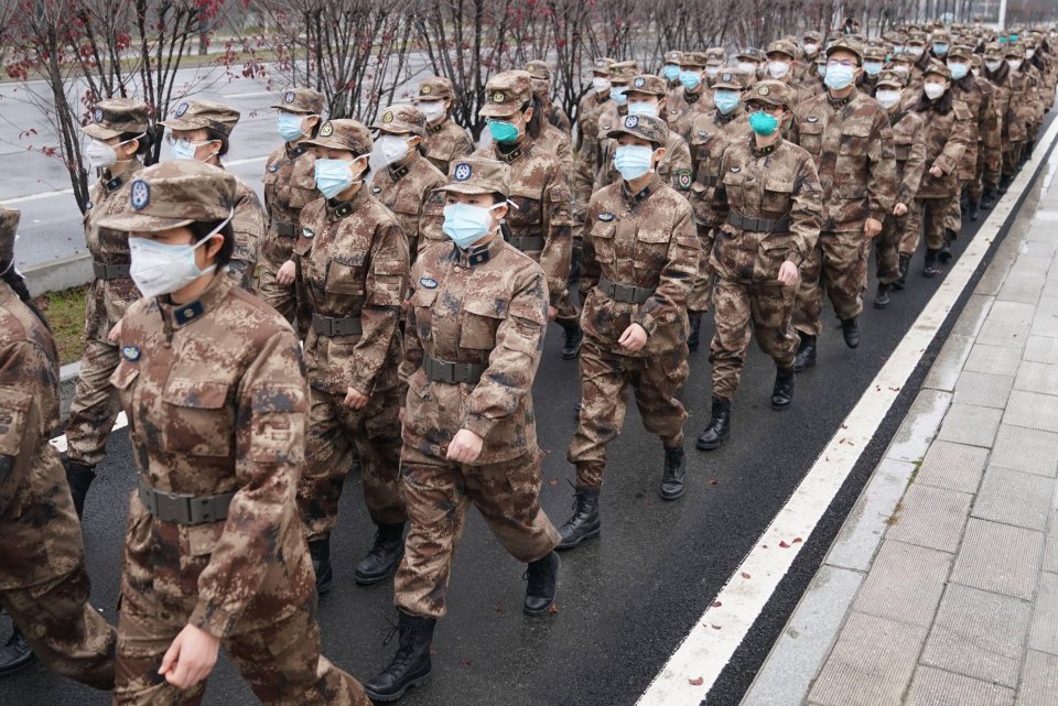  Members of a military medical team head for Wuhan Jinyintan Hospital in China's Hubei province