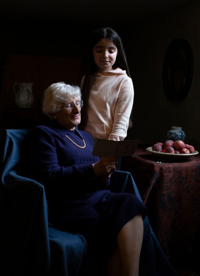  Yvonne Bernstein, originally from Germany, shows her granddaughter Chloe Wright her German ID card in one of Kate's poignant portraits