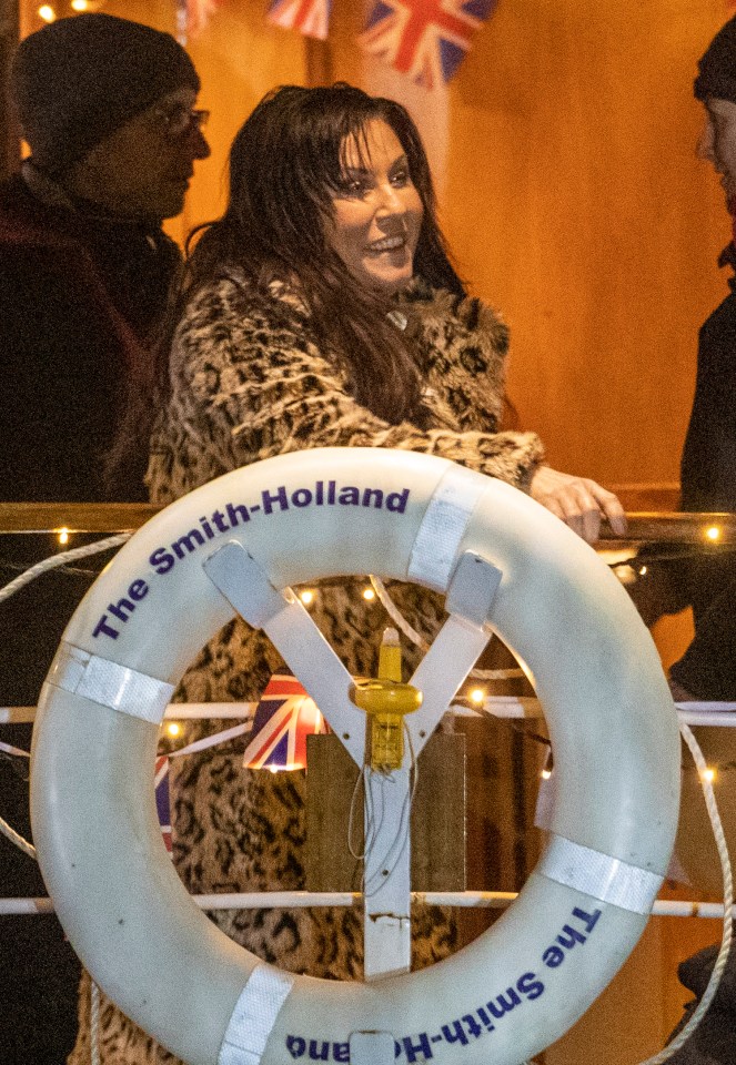  The star was pictured dressed in character as Kat Slater wearing a leopard-print coat