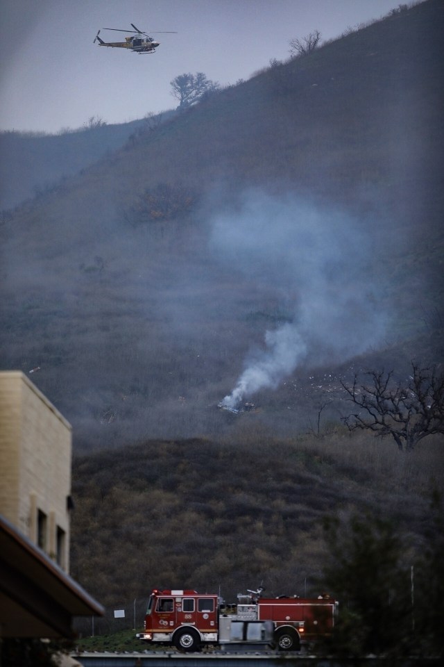 Smoke rises above the scene of the crash