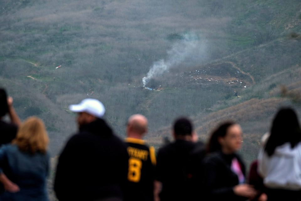 People gathered around the area to watch the smoke rise from the ground