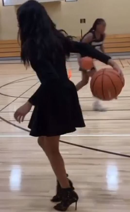  The 13-year-old dribbled the ball while wearing heels and a dress