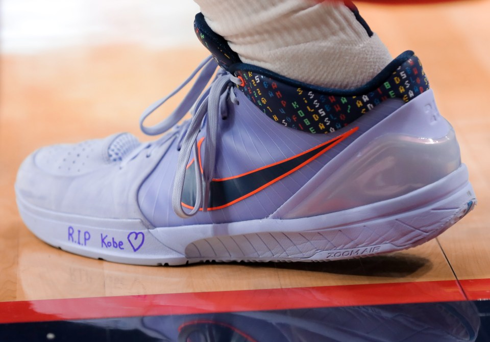 Players scribbled tribute messages to Bryant on their sneakers before stepping on the court Sunday