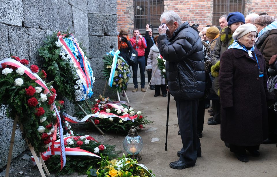  Flowers and wreaths were laid at the foot of an execution wall