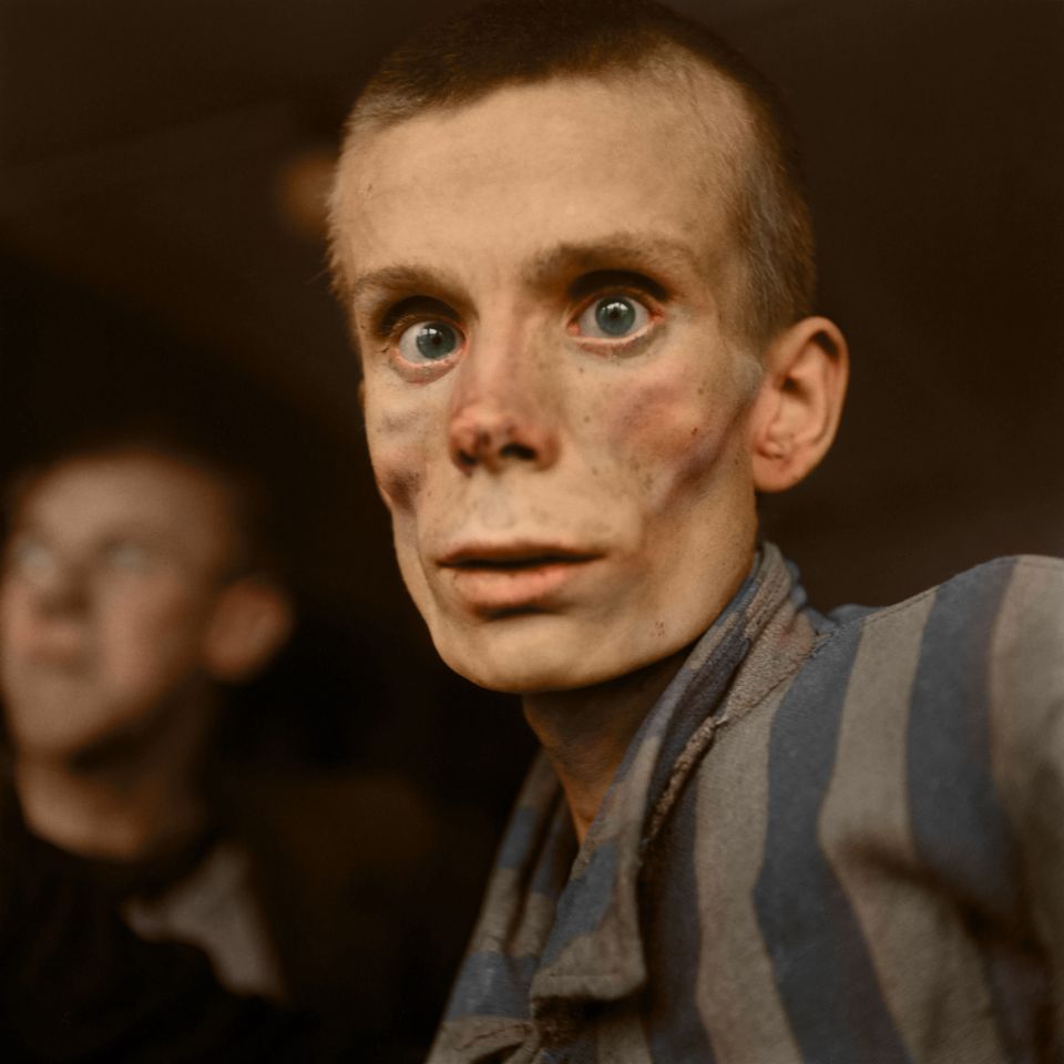  An emaciated 18-year-old Russian girl looks into the camera lens during the liberation of Dachau concentration camp in 1945. Dachau was the first German concentration camp, opened in 1933