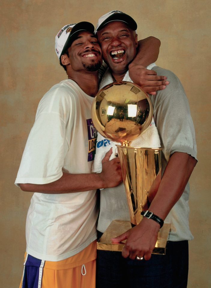  Bryant poses for a photo with his father, Joe "Jellybean" Bryant, after winning the NBA Championship in 2000