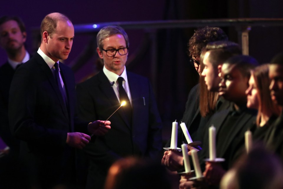  Prince William lights candles during the ceremony