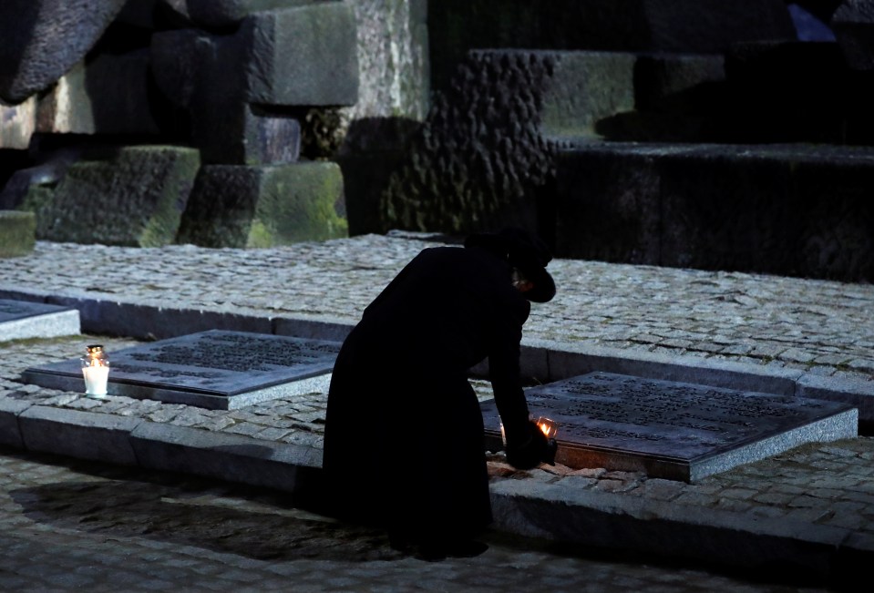 The Duchess of Cornwall lights a candle at the Monument to the Victims