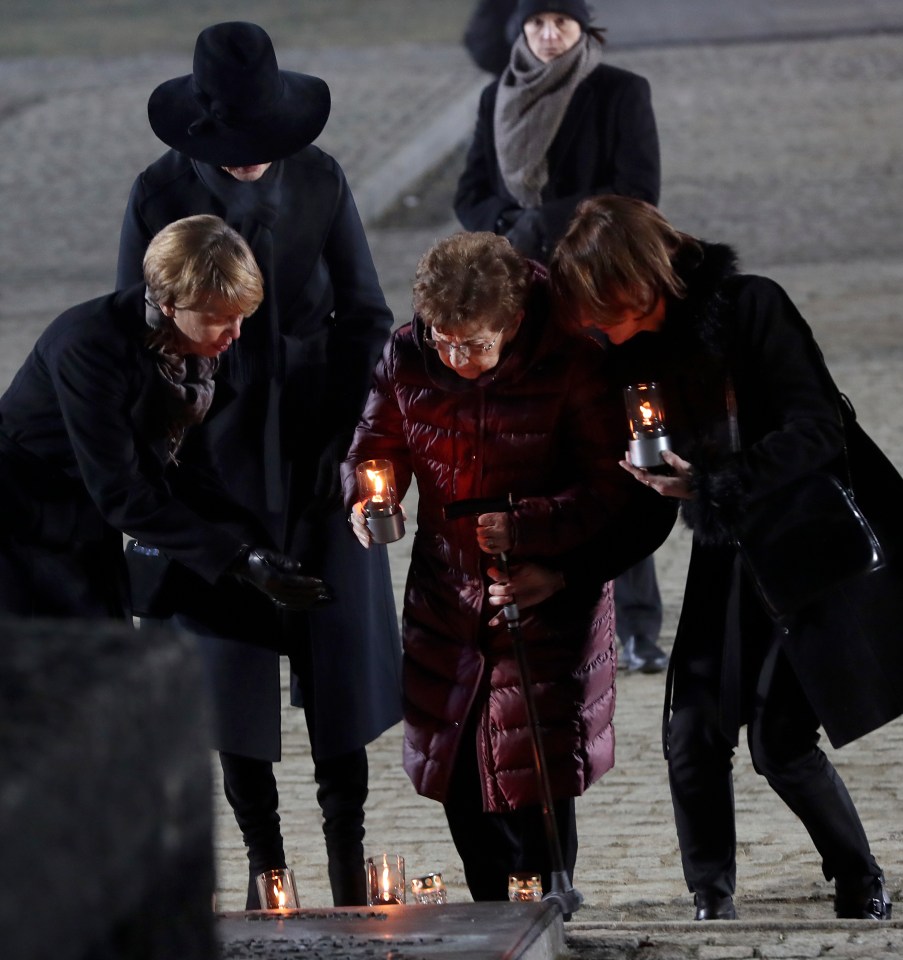 Holocaust survivor Bat-Sheva Dagan (centre) holding a memorial candle