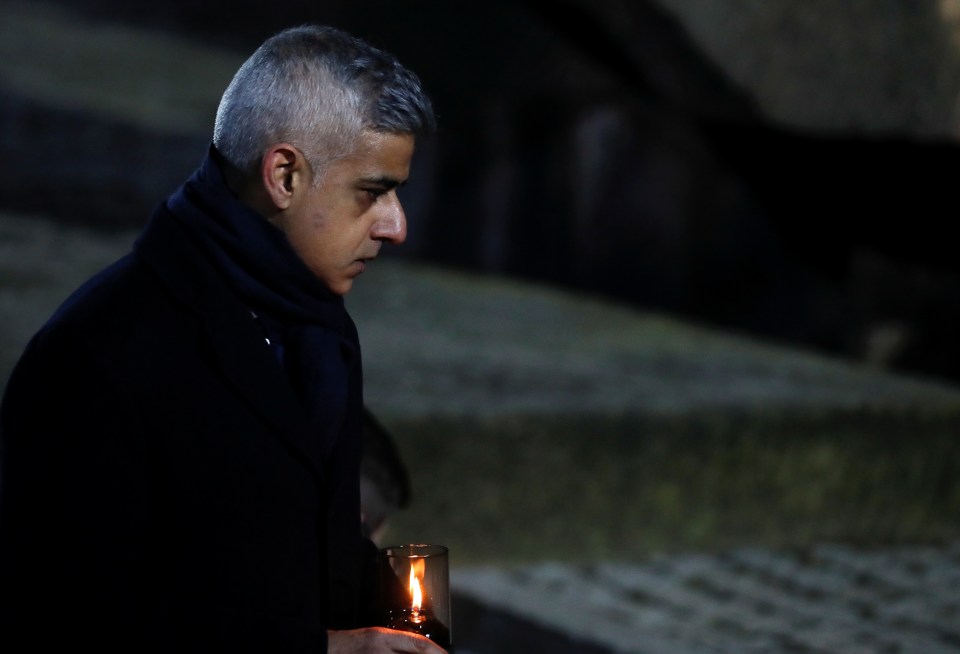 Sadiq Khan lights a candle during the moving memorial