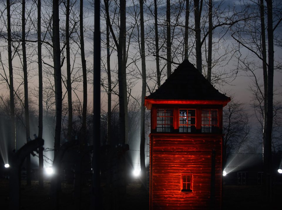  A guard tower stands illuminated at the former Auschwitz-Birkenau concentration camp