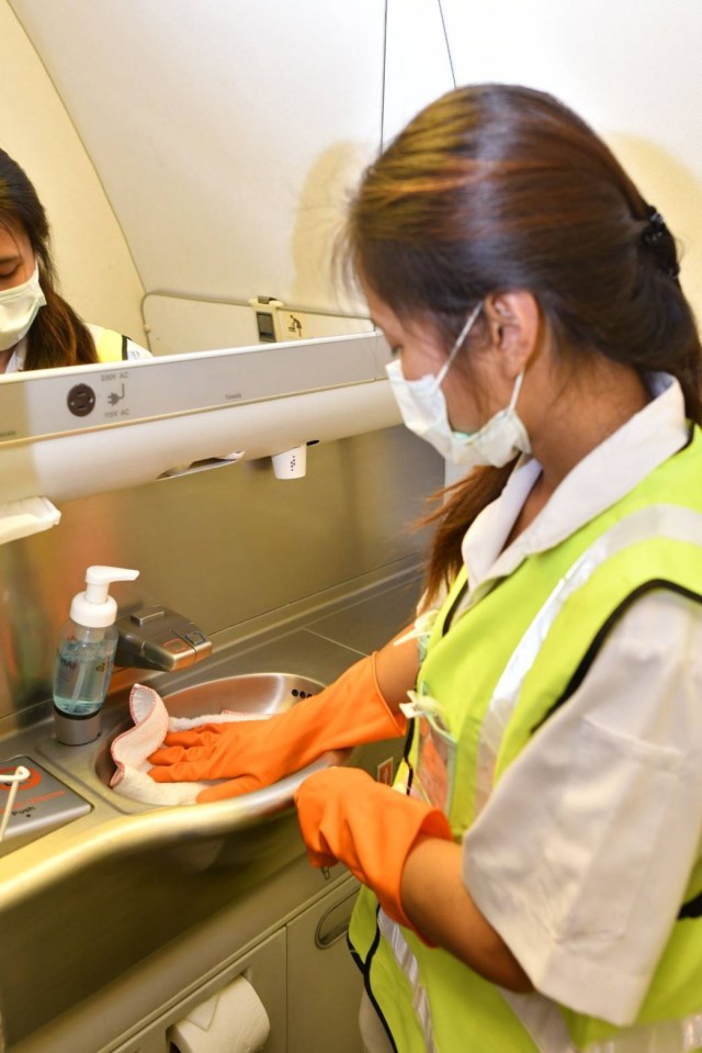  A woman wipes down surfaces after use to help curb the spiralling epidemic