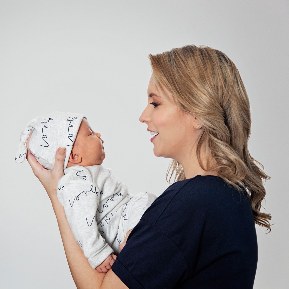  The new mother looked like a natural as she posed in front of the camera with her baby daughter