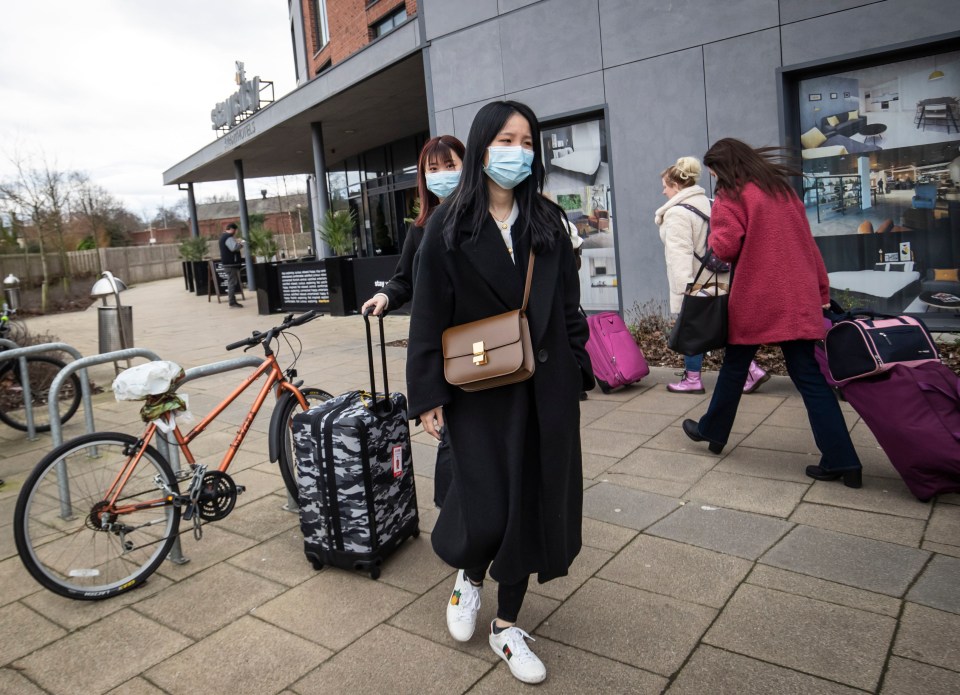 Two women wearing face masks leave the Staycity Hotel in the centre of York