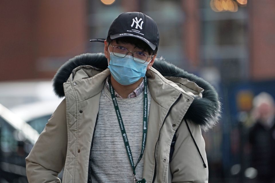  A man wears a mask in Newcastle upon Tyne, near where two patients who have tested positive for coronavirus