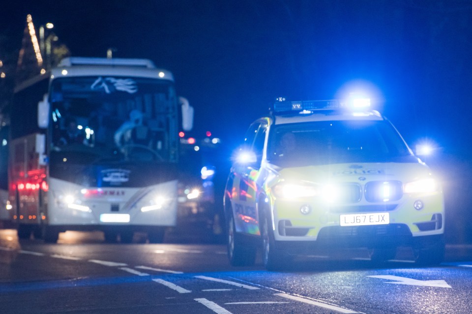  A police guard led the convoy of evacuees toward the hospital