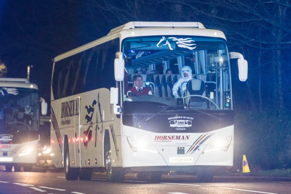 A bus carrying passengers evacuated from coronavirus-hit Wuhan arrives at Arrowe Park Hospital last night