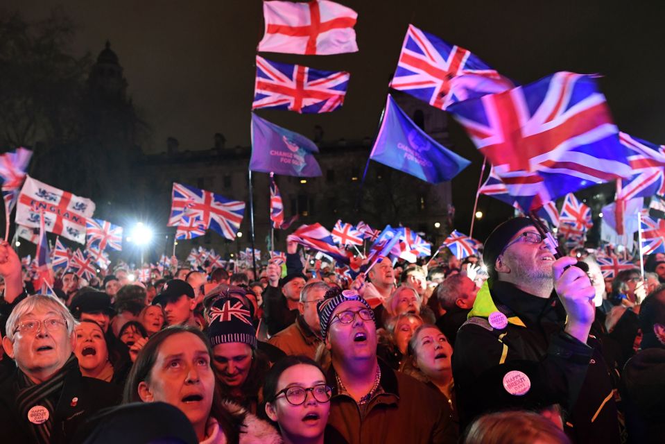  Crowds wave Union Jack flags in Westminster for a rally to celebrate one of the biggest days in the nation's history