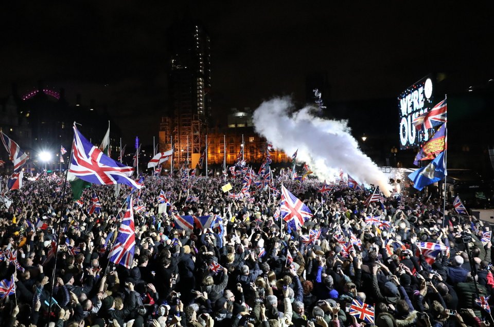  A smoke flare is let off as the clock hits midnight and crowds erupt in Wesminster