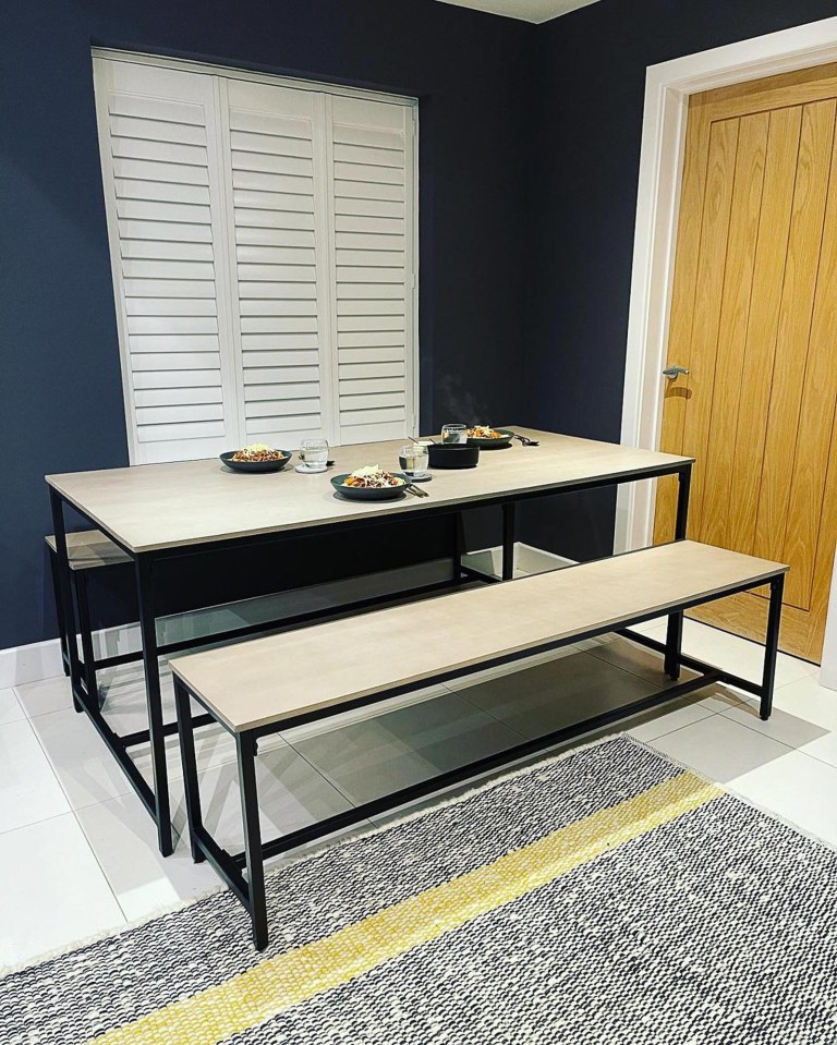  The kitchen room boasts a modern dining table for the family to sit and eat dinner on