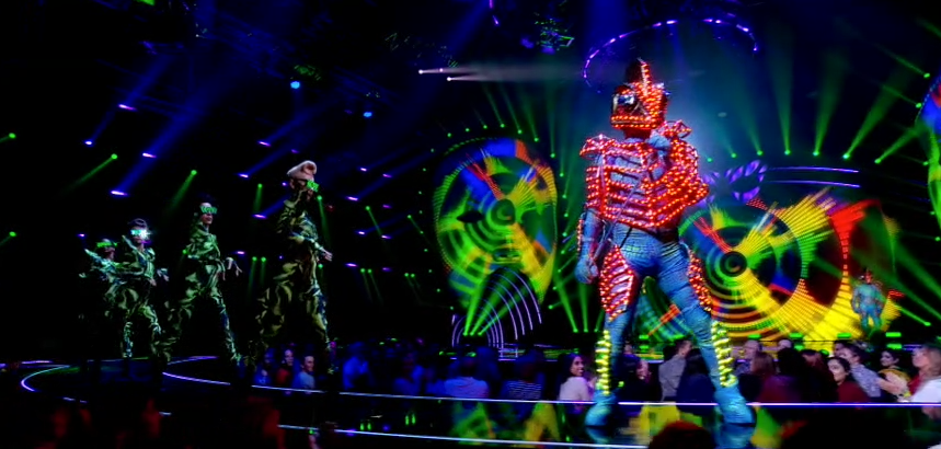  Trailed by female backing dancers in quirky outfits, the Chameleon struts towards the judges panel