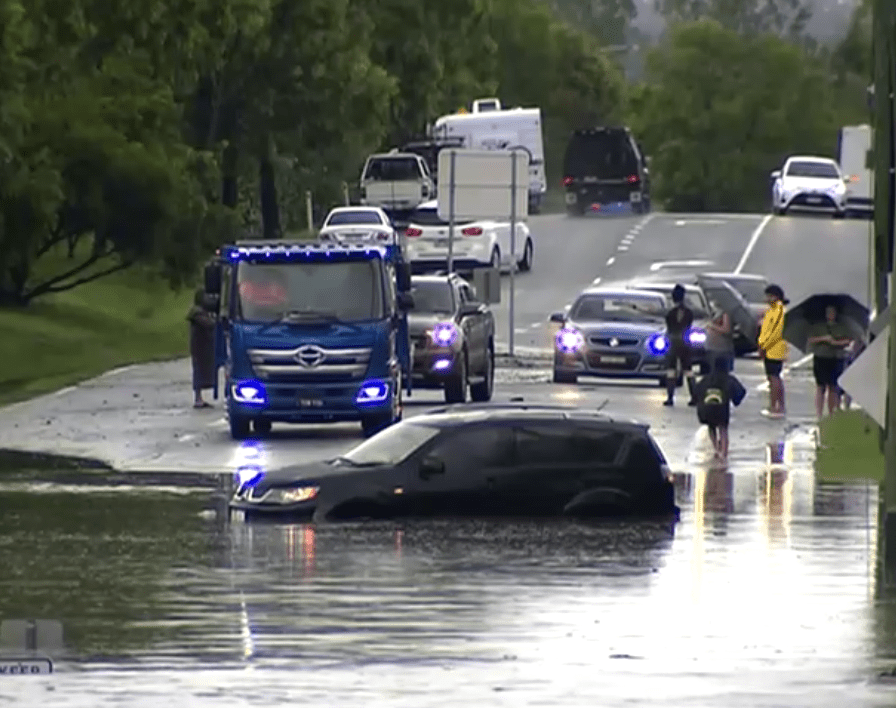  A car is trapped in floodwater after torrential rain