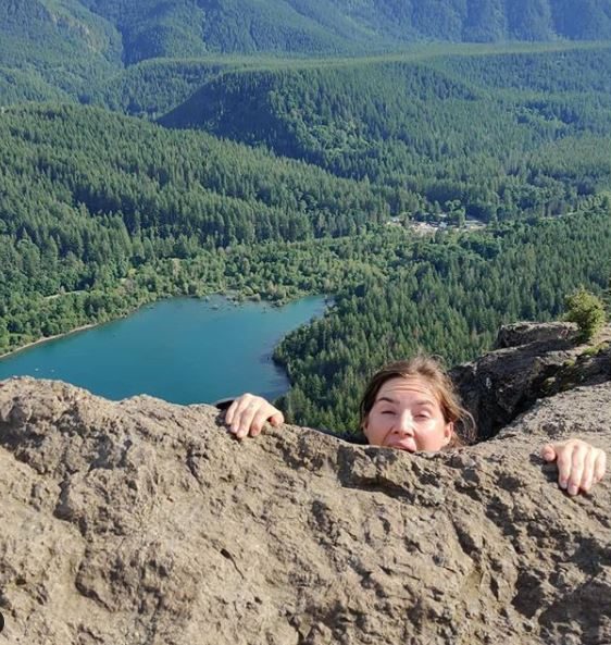  Knox clings to a mountainside with just her face visible in a bizarre photo