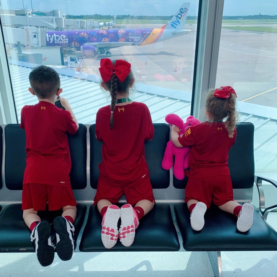  All three children watching planes take off at the airport