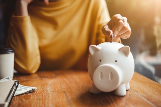 Person putting money in a piggybank