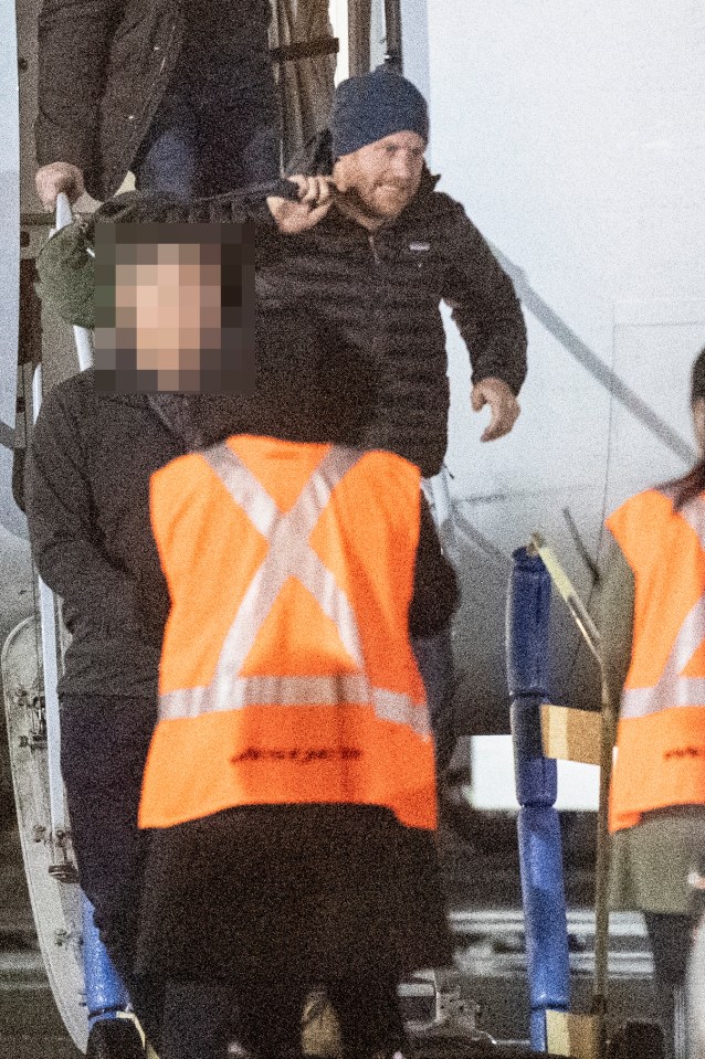  Harry is seen accompanied by security as he arrives in Canada after leaving the UK last month