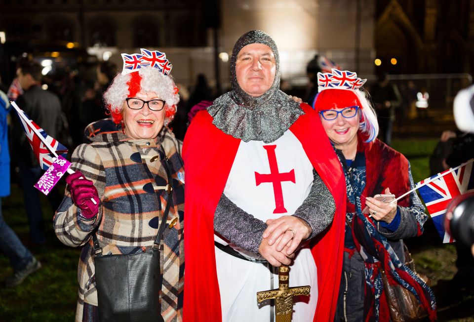  Three people dressed in Union Flag regalia and one as a medieval crusader pose at a rally in Parliament Square to celebrate the UK leaving