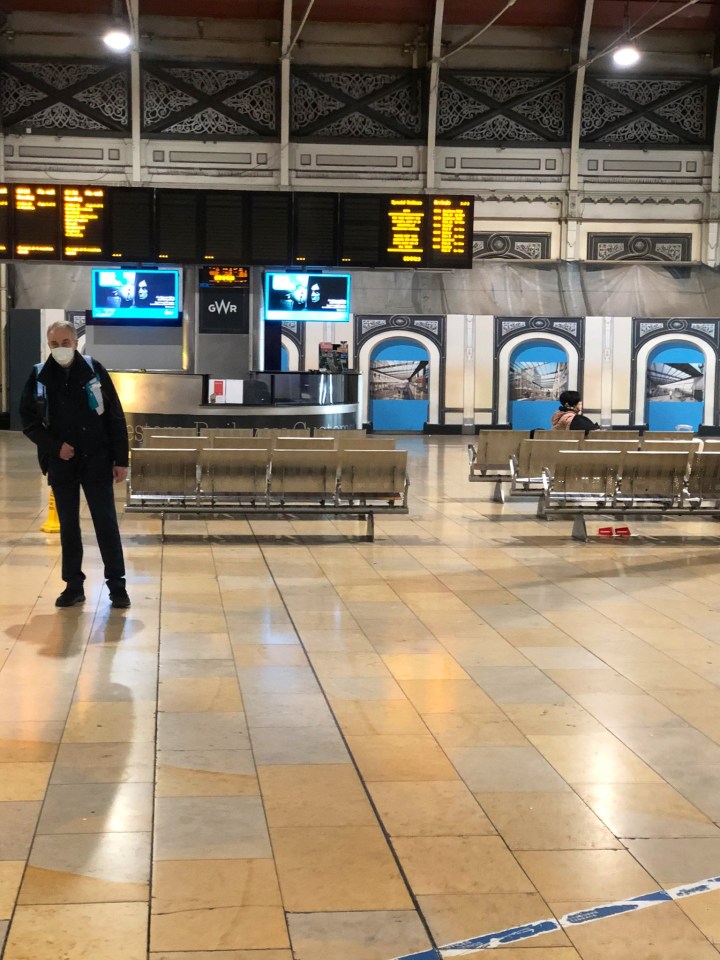 A passenger tweeted this picture from Paddington Station showing a woman sat on surrounded by rail workers