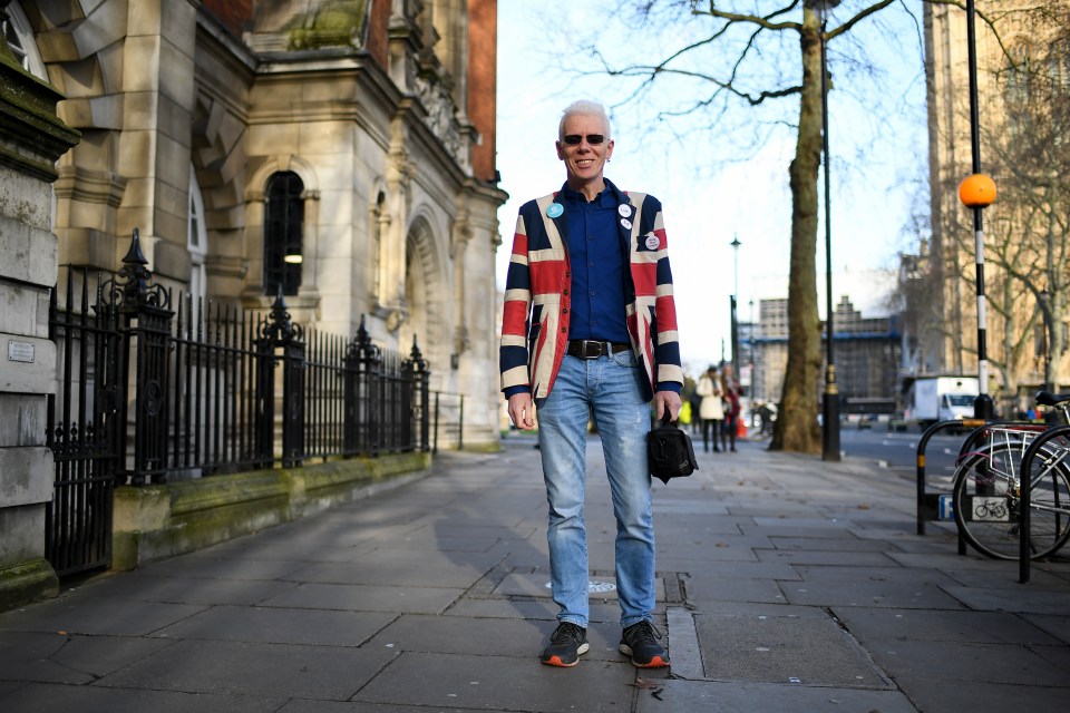  A man wearing a British Union flag themed jacket poses for a photo in Westminster