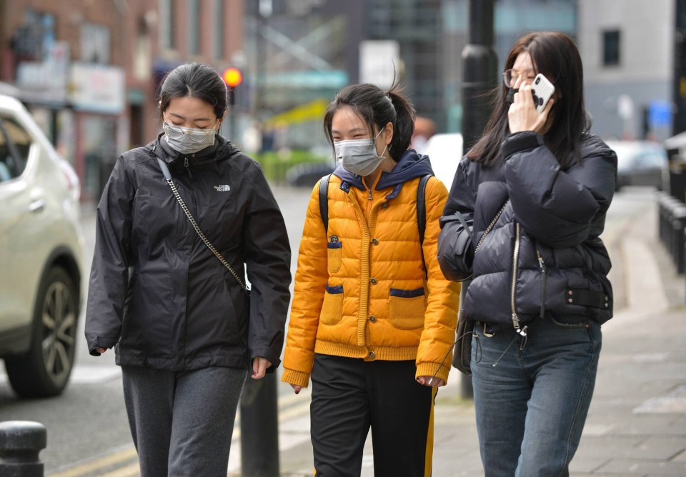 Members of the public wear face protection masks in Newcastle after it was confirmed two victims who tested positive for coronavirus are being treated at Newcastle