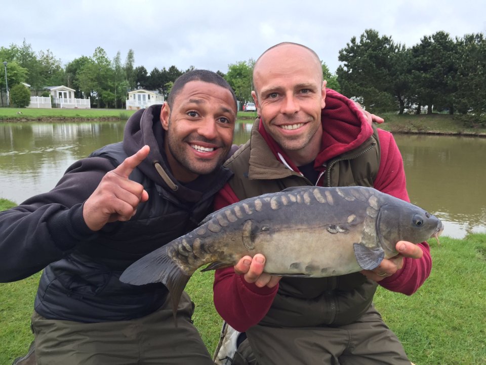  Kell Brook, who is giving up on fighting rival Amir Khan, shows off a fish with athlete pal Dean Macey