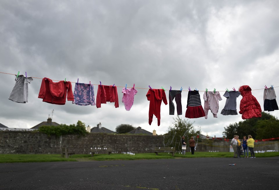  Infant and baby clothes are hung on a line to mark the children buried in unmarked graves