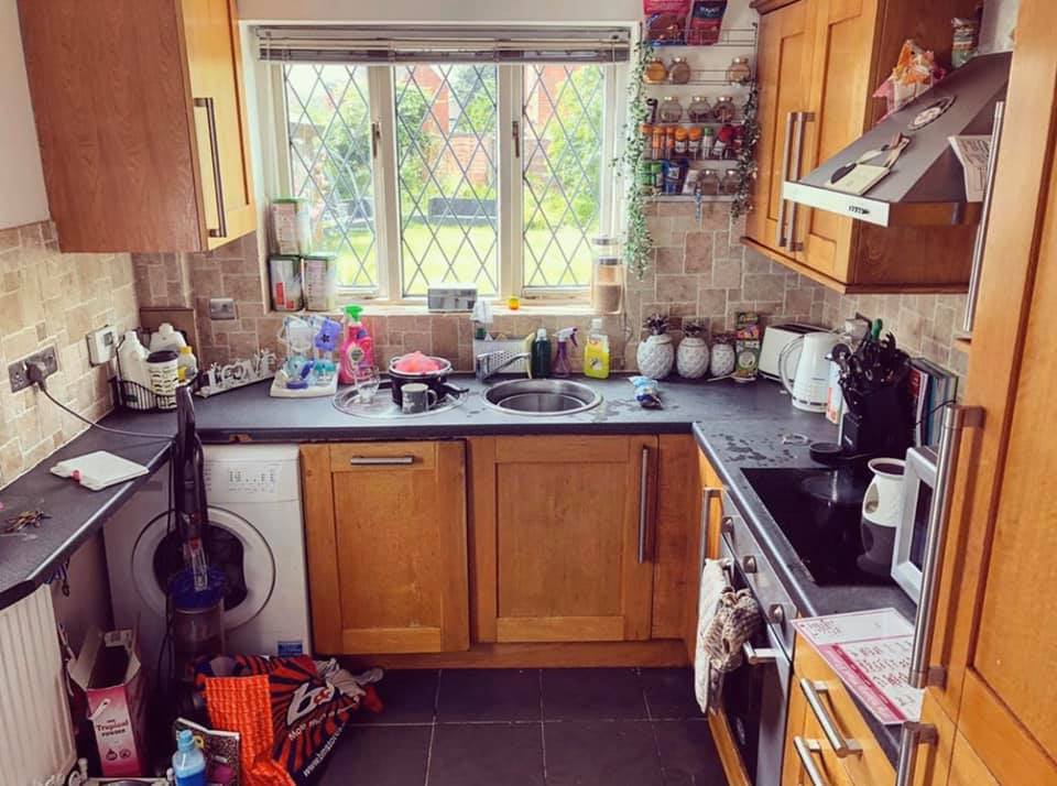 The kitchen was previously dated and cluttered, with wooden cabinets and dark worktops