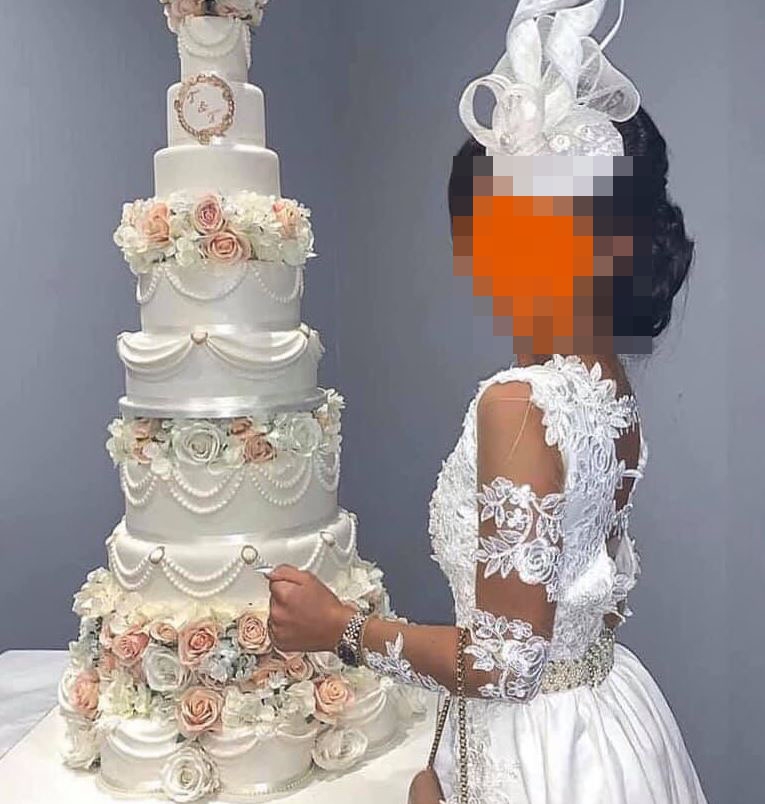 This woman was a guest at a wedding but appeared to be wearing a white wedding dress of her own