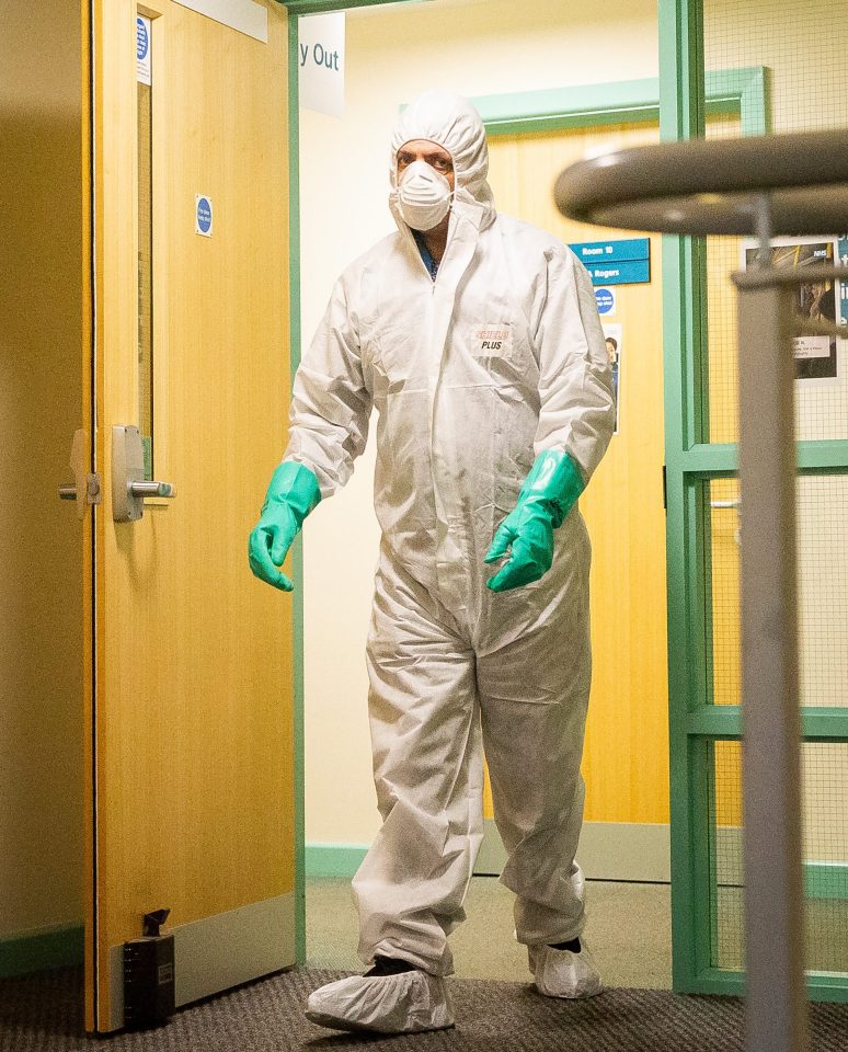  A worker in a hazmat suit cleans the County Oak medical centre in Brighton, East Sussex