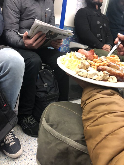 The workman ate a full English breakfast on the London tube