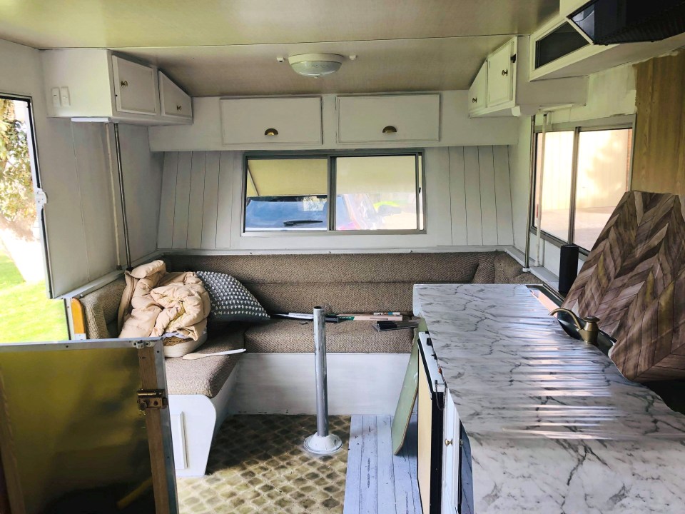 She used paint and rolls of vinyl to jazz up the dated caravan