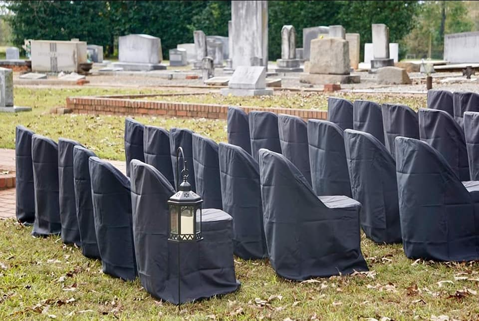 Guests were sat on black chairs in and amongst the grave stones 