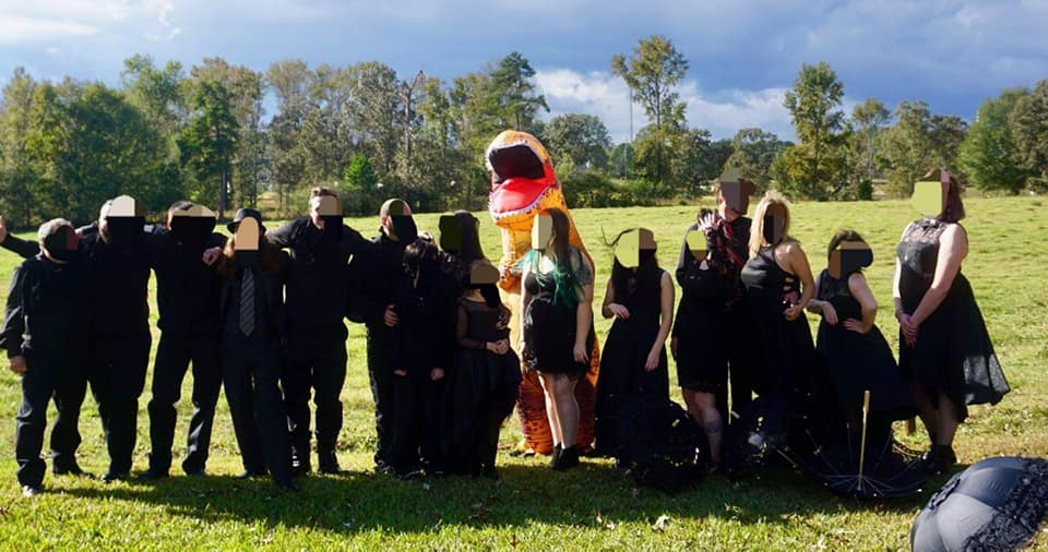 All of the guests were dressed in black apart from the bride's son, who wore an inflatable t-rex costume