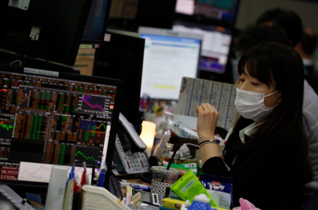 A South Korean dealer wearing a protective mask