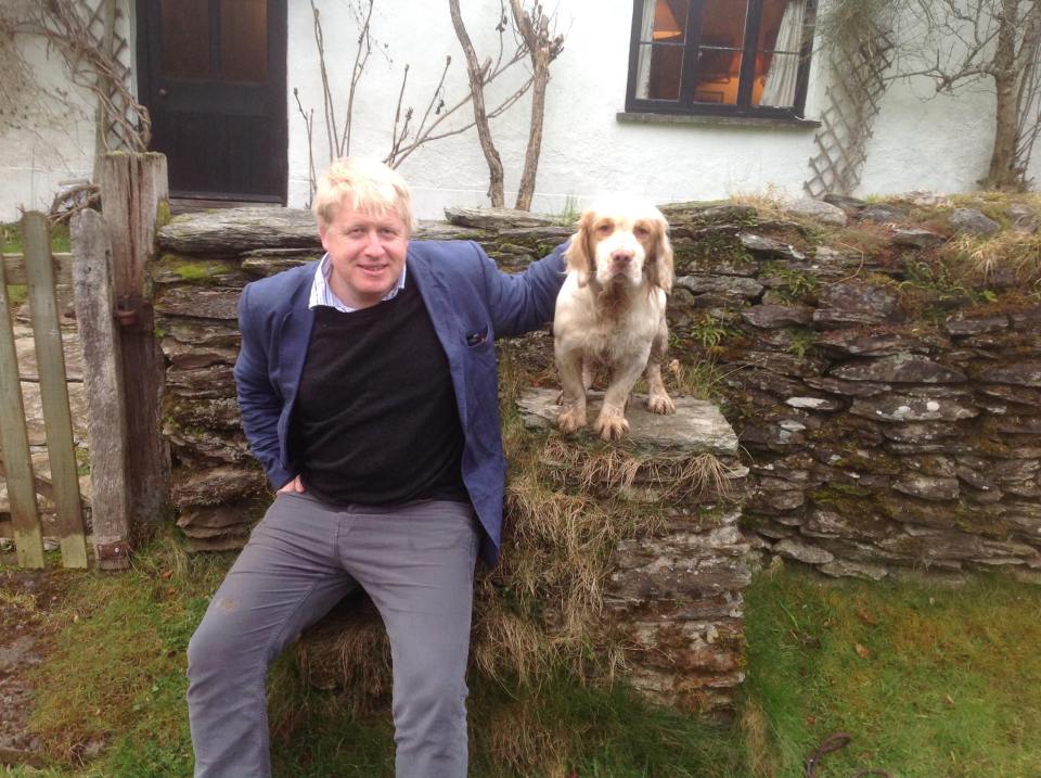  Boris Johnson pictured visiting the property and posing with the couple's dog