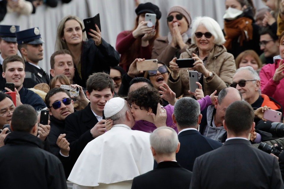  Francis is kissed by a worshipper on Ash Wednesday