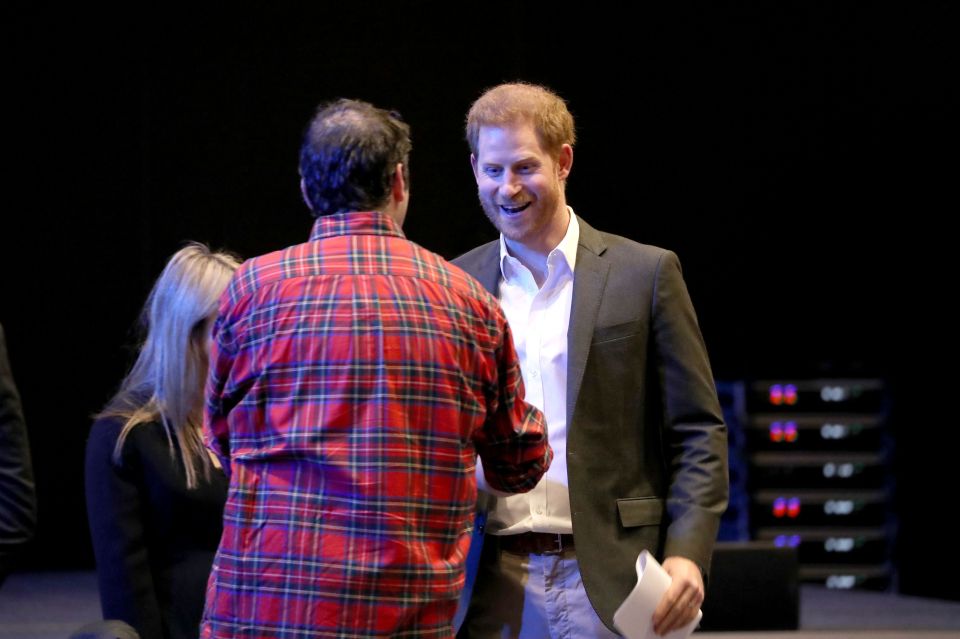  Prince Harry smiles as he is greeted at the eco-tourism event