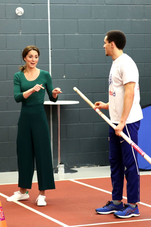  Kate seems unsure of the pole vaulting pole at the stadium