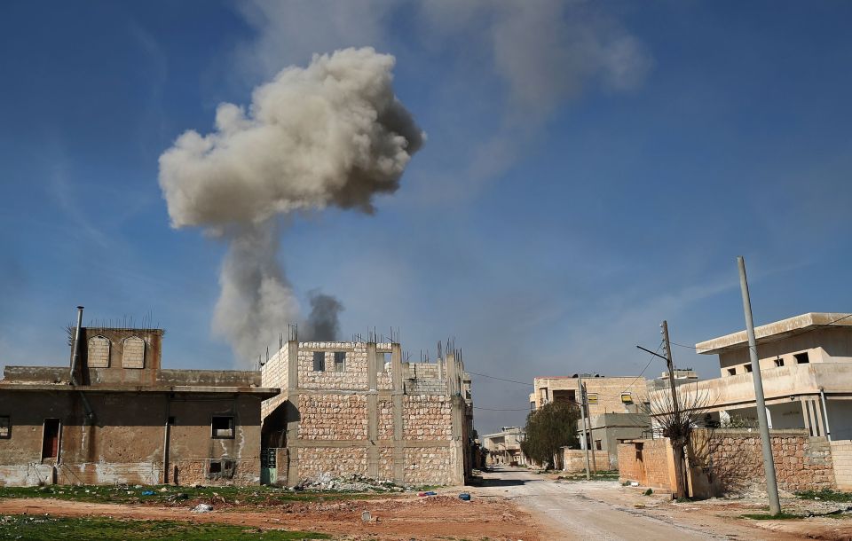  Smoke billows over Saraqeb, a strategic town retaken by Turkish rebels from regime forces on Thursday