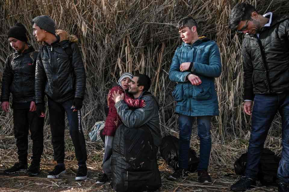  A dad hugs his child after they made it to Greece